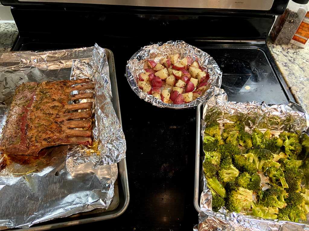 Lamb, potatoes, and broccoli in baking pans
